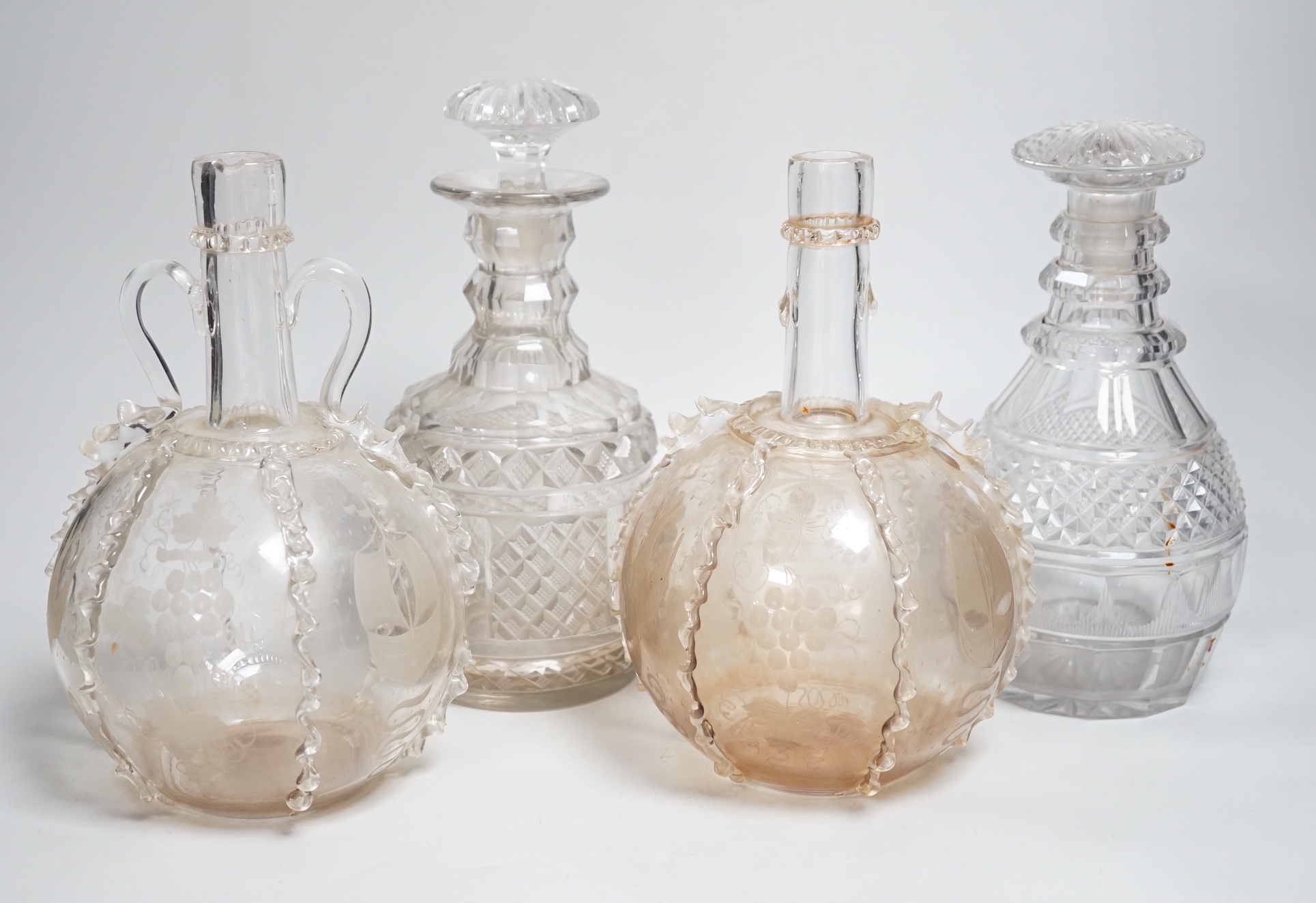 Two Dutch wheel engraved glass flasks and two Regency cut glass decanters, flasks 23cm high (4)